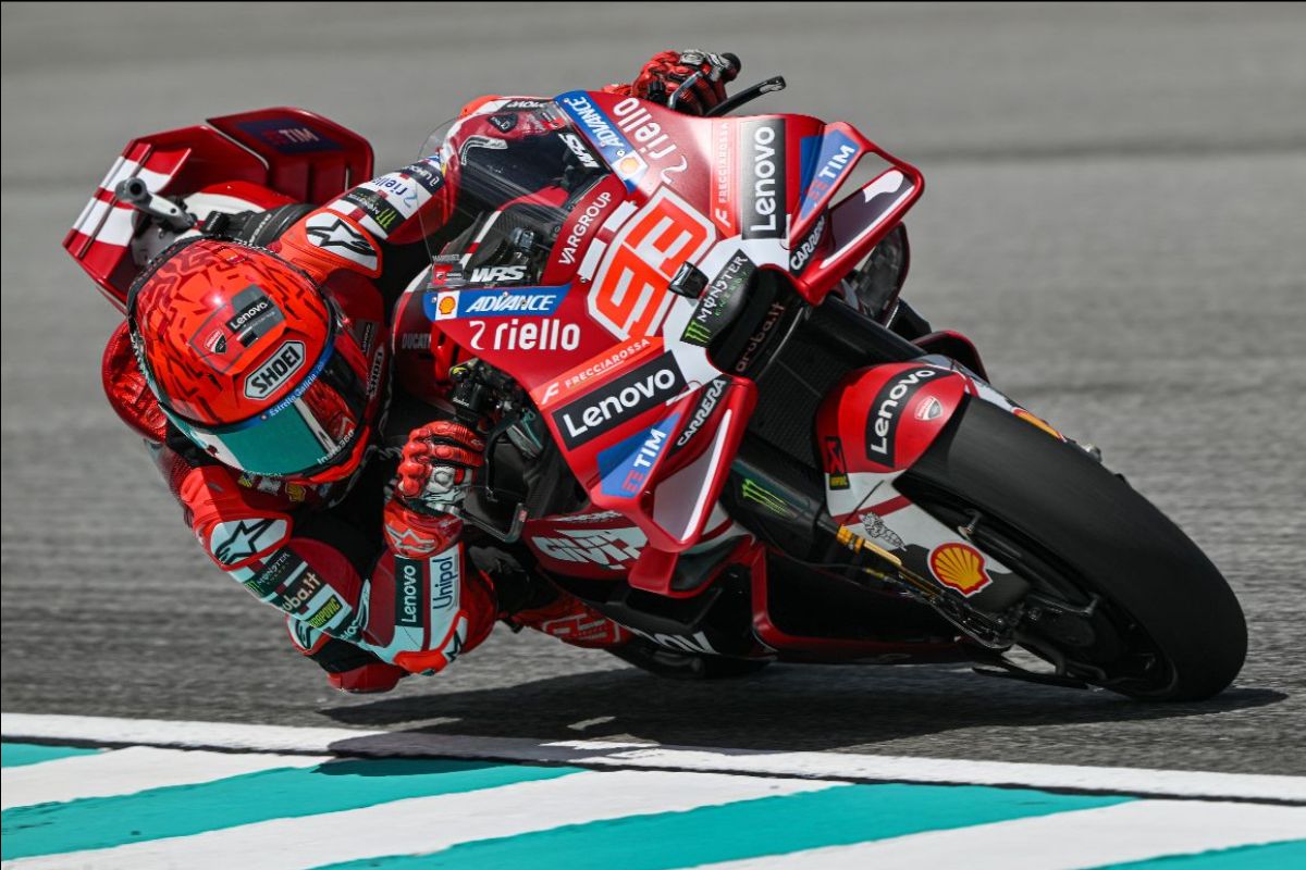 Marc Marquez, number 93, leaning his red Ducati Lenovo MotoGP bike into a corner at Sepang during Friday practice for the PETRONAS Grand Prix of Malaysia