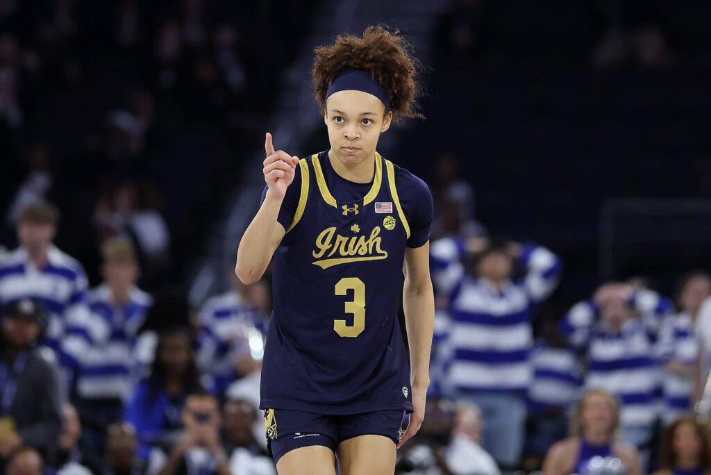 Notre Dame guard Hannah Hidalgo, number 3, in a navy Irish jersey on court during a women's college basketball game