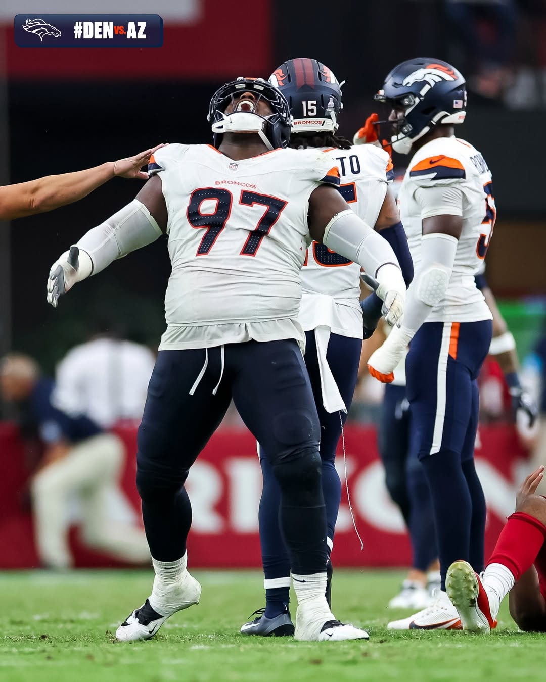Denver Broncos players celebrate on the field after the win over the Arizona Cardinals