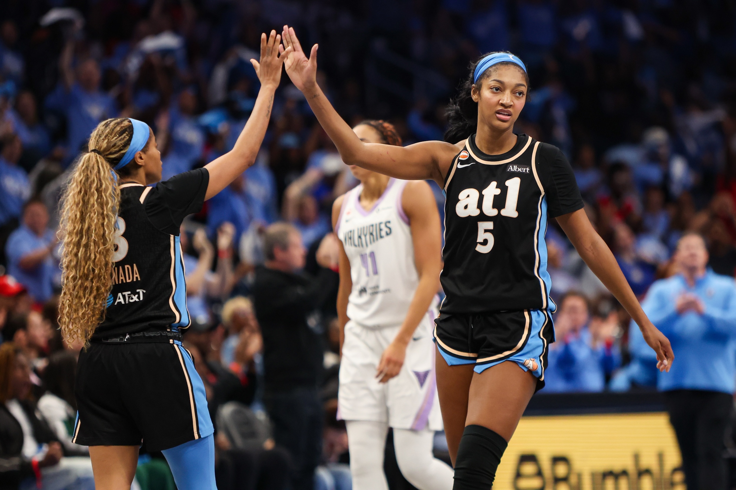 Angel Reese high-fives Jordin Canada during WNBA Finals Game 3