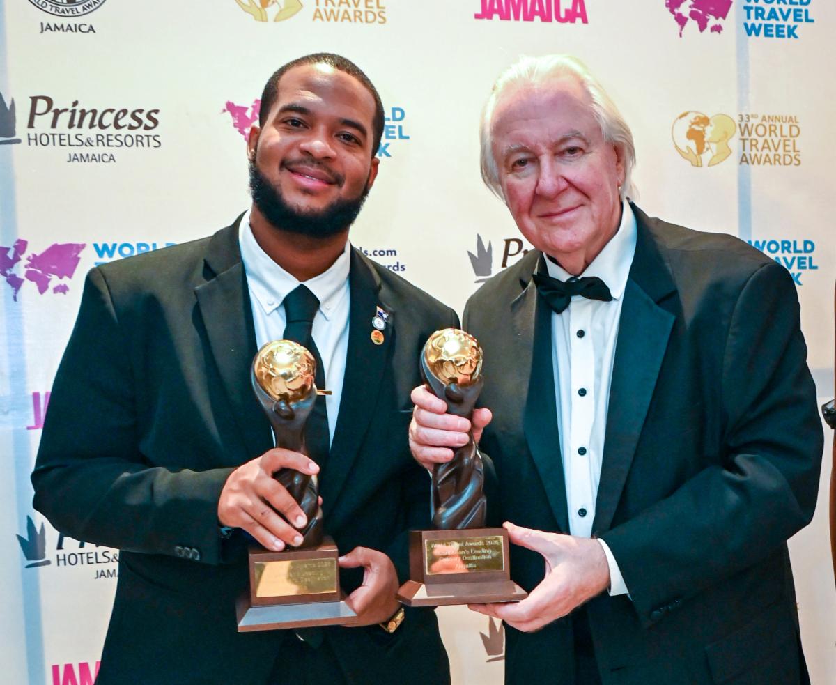 Jameel Rochester accepts Anguilla's World Travel Awards from Graham Cooke
