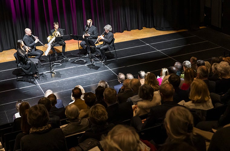 A small chamber ensemble performs on stage in front of a close audience at an Atlanta Symphony Orchestra concert.