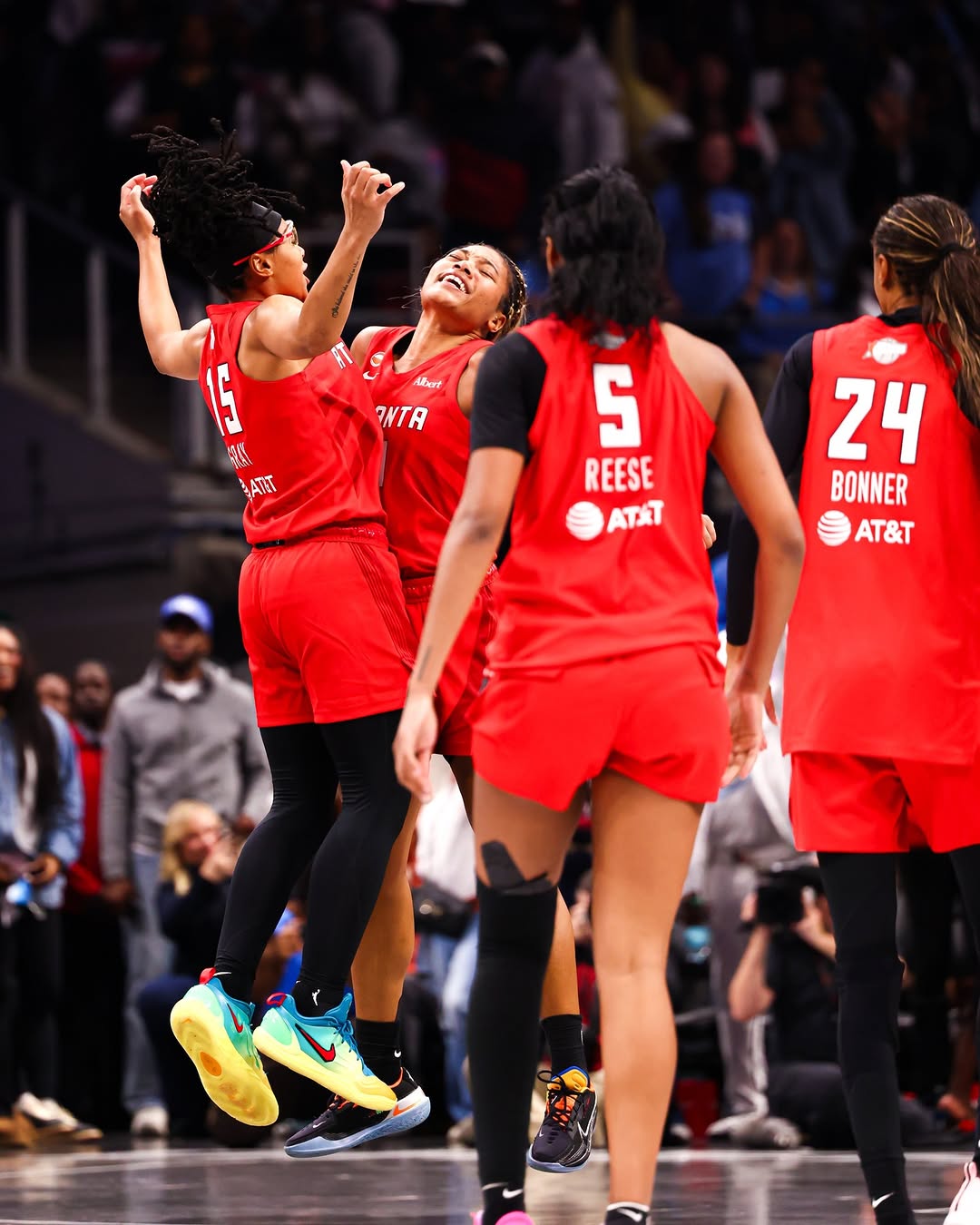 Atlanta Dream players Allisha Gray, Angel Reese and their teammates celebrate on the court during Game 6 of the WNBA Finals at State Farm Arena