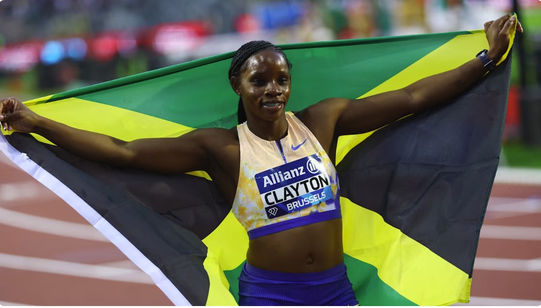 Tina Clayton celebrating with the Jamaican flag after winning the Diamond League final in Brussels