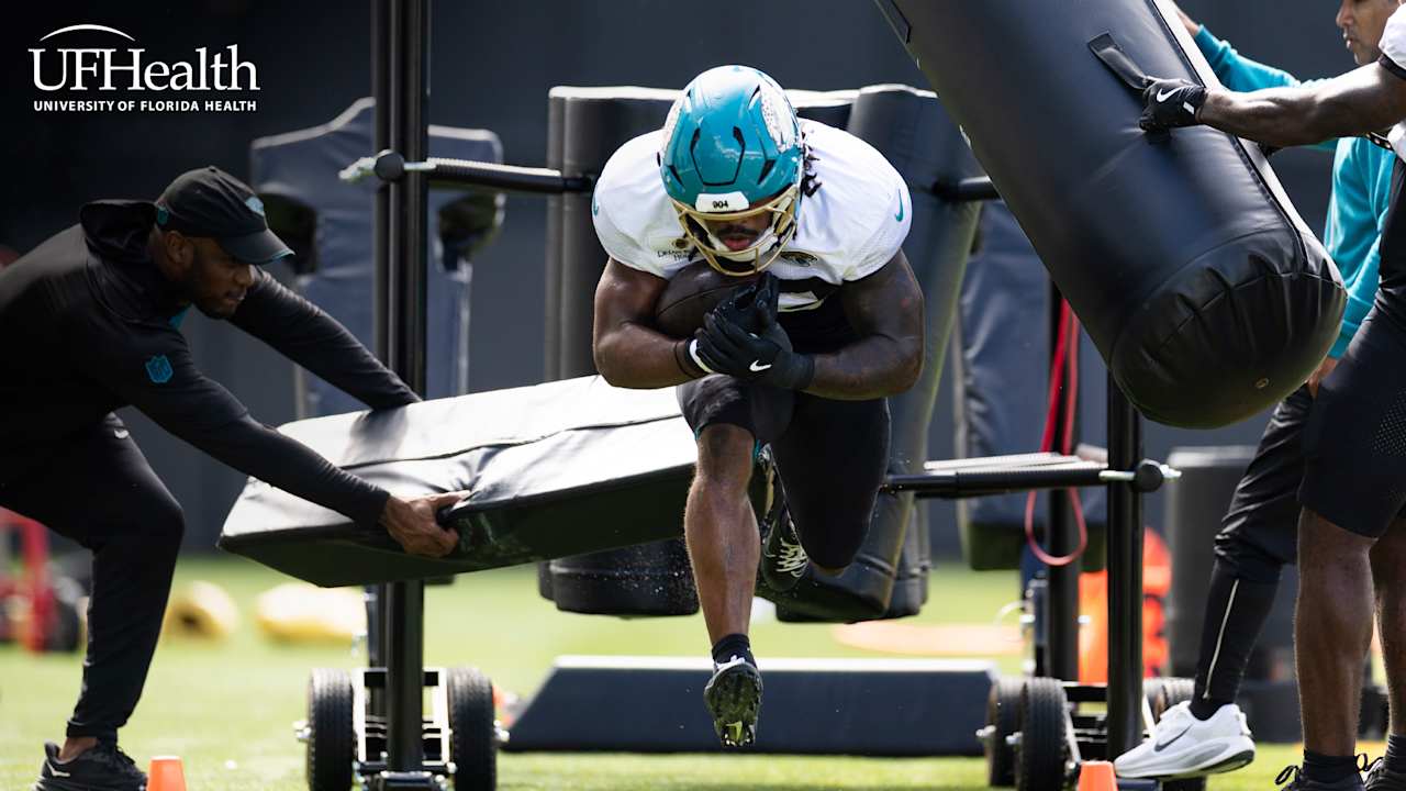 A Jacksonville Jaguars player runs through a practice drill with the ball.