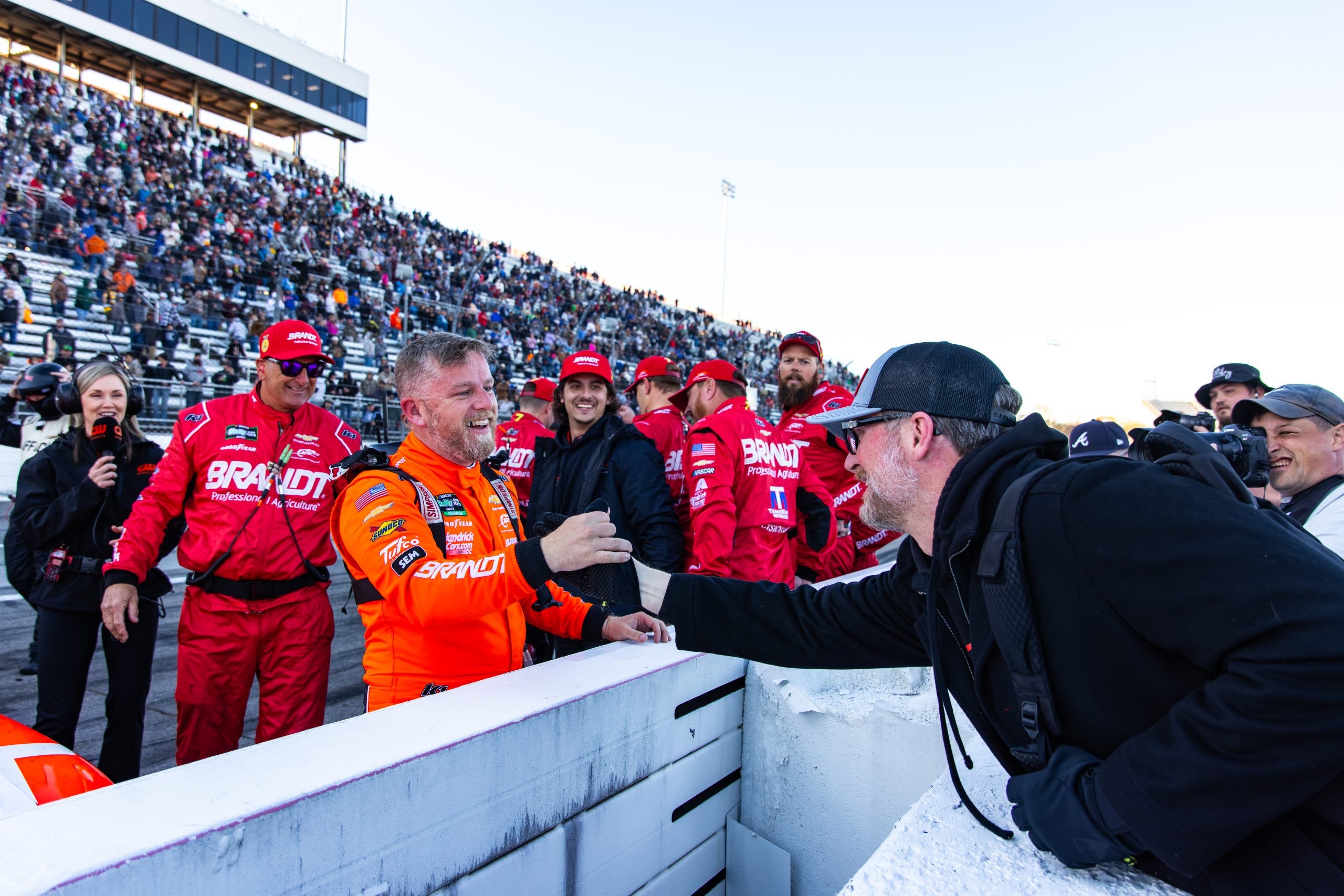 Justin Allgaier greets team owner Dale Earnhardt Jr. on pit road at Martinsville Speedway after winning the spring race there on March 28, 2026.