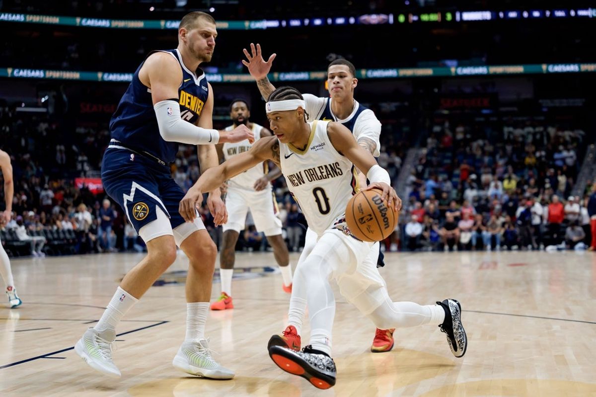 New Orleans Pelicans guard Jeremiah Fears dribbles around Denver Nuggets center Nikola Jokic during the first half on Oct. 28, 2026 at Smoothie King Center in New Orleans