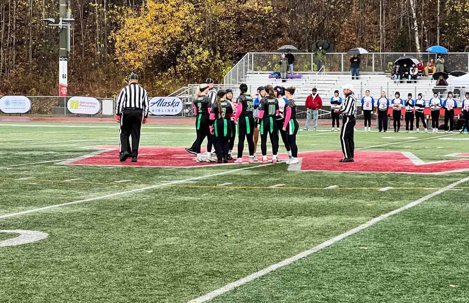 North Pole and Colony meet at midfield before the ASAA state championship game in Wasilla.