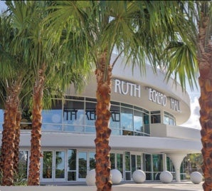 The entrance of Ruth Eckerd Hall in Clearwater, Florida, framed by palm trees.