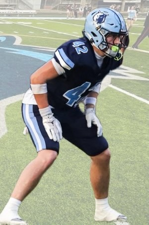 Newsome Wolves player in a navy uniform and light blue helmet set in his stance on the field
