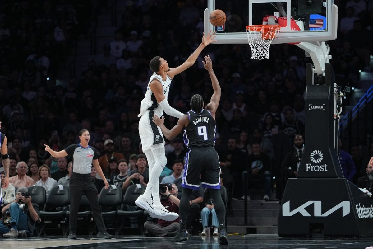 San Antonio Spurs forward Victor Wembanyama shoots in front of Sacramento Kings forward Precious Achiuwa on Oct. 27, 2026 at Frost Bank Center
